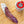 Load image into Gallery viewer, il porcellino salumi's black truffle salami pictured from above and cut into slices on a cutting board next to a jar of black truffle salt.

