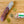 Load image into Gallery viewer, A product photo of il porcellino salumi's Finocchiona salami shot from above. Half of the salami in packaging is cropped out of the image and another chub of salami is cut into slices.
