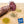 Load image into Gallery viewer, A close up picture looking at the cross section of il porcellino salumi's Finocchiona salami. Half of the salami is a whole chub and the other half is cut into slices on a cutting board with herbs and spices. Plus the Good Food Award Finalist 2021 seal is placed on the picture.
