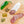 Load image into Gallery viewer, A product photo of green chile tequila salami shot from above. Half of the salami is whole and the other half is cut into slices on a cutting board with a green chile, herbs and spices.
